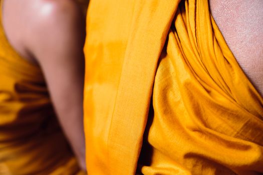 Yellow robe of Buddhist monks, Closeup on buddhist monk