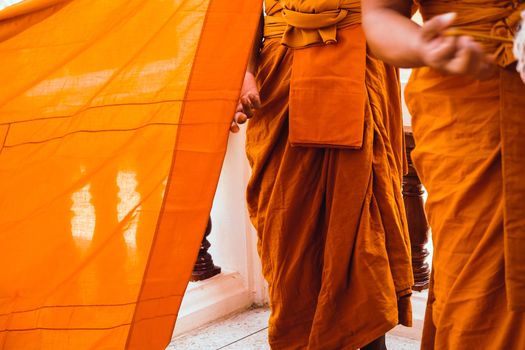 Yellow robe of Buddhist monks, Closeup on buddhist monk