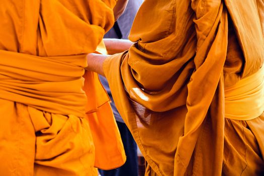 Yellow robe of Buddhist monks, Closeup on buddhist monk