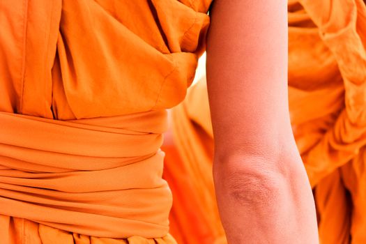 Yellow robe of Buddhist monks, Closeup on buddhist monk