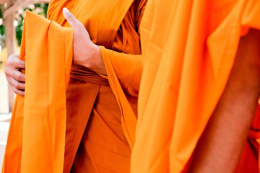Yellow robe of Buddhist monks, Closeup on buddhist monk