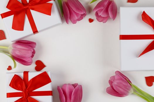 Pink tulip flowers gifts red hearts and gifts composition isolated on white background top view with copy space. Valentine's day, birthday, wedding, Mother's day concept. Copy space