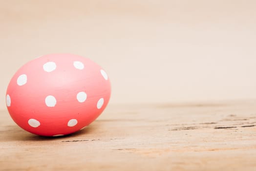 Beautiful Easter Pink egg on wooden background, Easter day concept