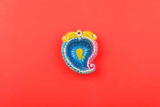 Happy Diwali Day, Flat lay top view Colorful Clay Diya lamps on red background and copy space for your text