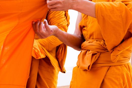 Yellow robe of Buddhist monks, Closeup on buddhist monk