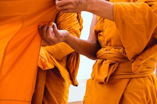 Yellow robe of Buddhist monks, Closeup on buddhist monk