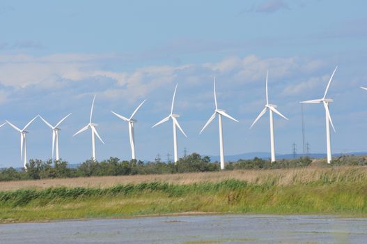 landscape filled with wind turbine in the Camargue, France. new energies