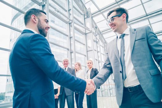Handshake of business people in the lobby of an office building