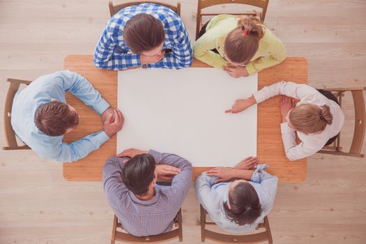 Hipster business teamwork brainstorming planning meeting concept, people team sitting around the table with white paper and pointing, copy space for content
