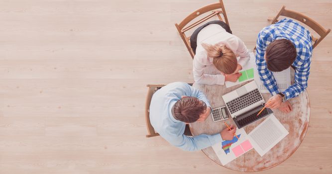 Business team meeting, people in casual clothes working with financial statistics at office desk