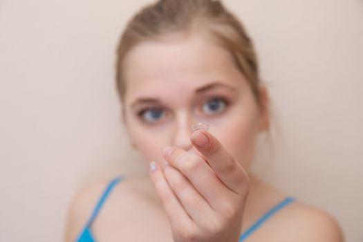 girl with contact lens on blurred background