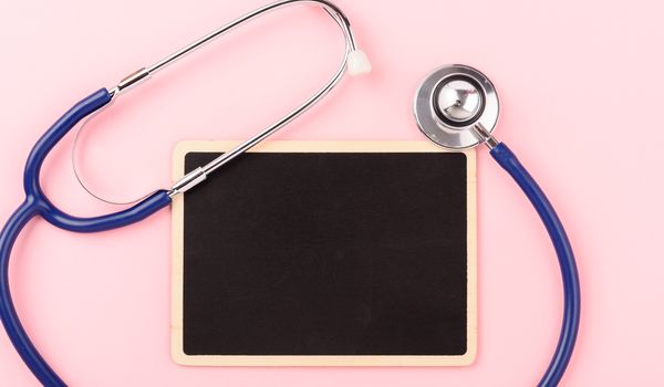 Doctor's Day concept, flat lay top view, equipment medical red heart stethoscope on pink background, care patient in hospital with black board copy space for text