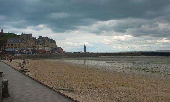 CANCALE, FRANCE - April 7th 2019 - Atlantic ocean shore with pier and town