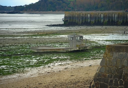 Fishing boat on beach during low tide at Cancale, France