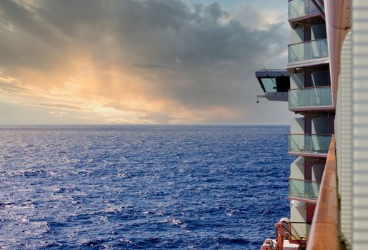 Balconies and Life Boats on the side of a cruise ship over deep blue sea