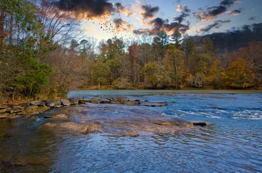 A river in the fall reflecting the blue sky