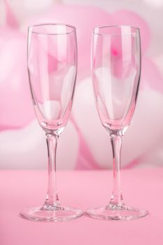 Valentines day champagne flutes glasses on pink balloons background with copy space for text