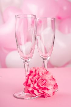 Valentines day champagne flutes glasses on pink balloons background with copy space for text