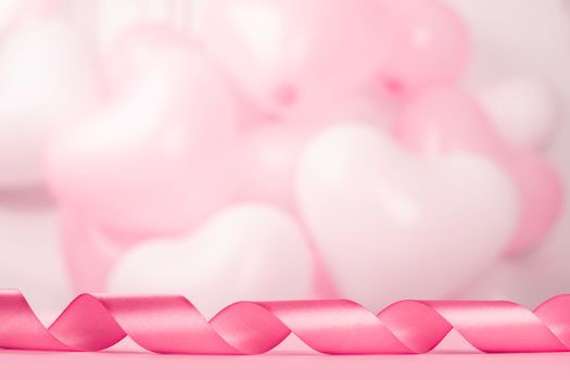 Valentine day background with pink curly satin ribbon and many balloons with copy space for text