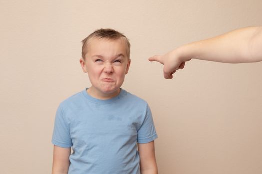 boy who got in trouble is still making funny faces.