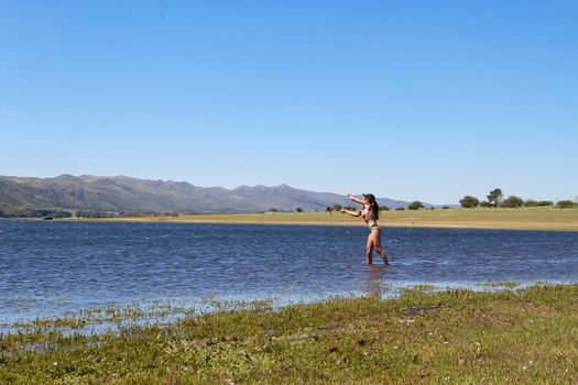 beautiful young woman fishing the mountain lake