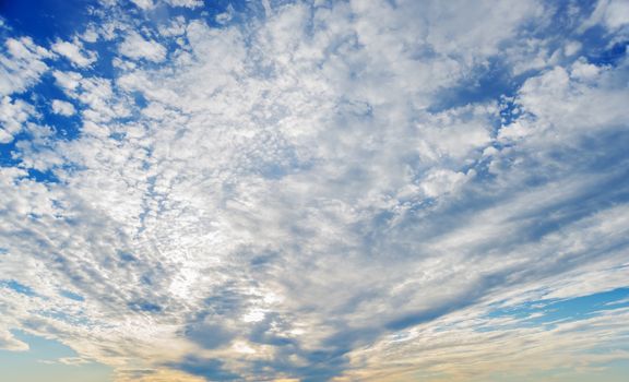 Panorama of vast blue summer sky with fluffy white clouds