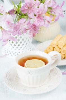 Continental breakfast with sweet waffles and tea with lemon