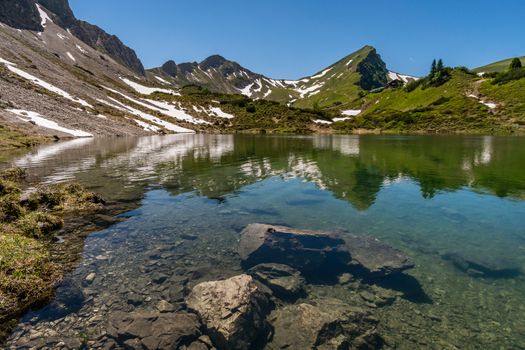 Fantastic hike in the Tannheim Mountains from the summit of Neunerkopfle over Landsberger hut to the beautiful Vilsalpsee.