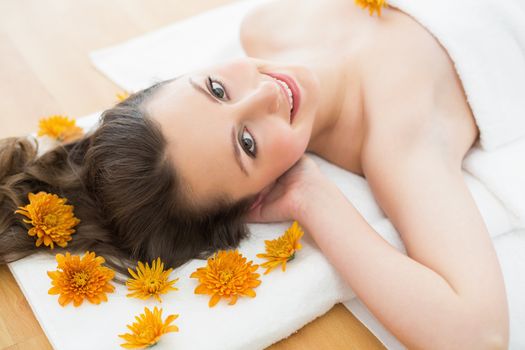 Overhead portrait of a young brunette lying on massage table in beauty salon