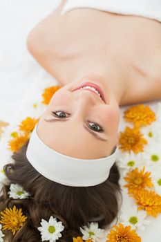 Overhead portrait of a beautiful young woman with flowers in beauty salon