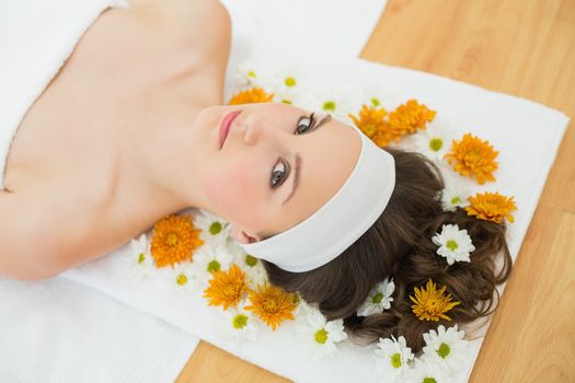 Overhead portrait of a beautiful young woman with flowers in beauty salon