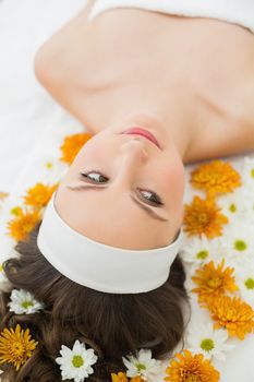 Overhead view of a beautiful young woman with flowers in beauty salon