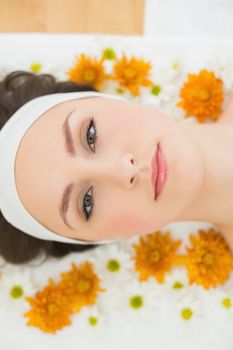 Overhead portrait of a beautiful young woman with flowers in beauty salon