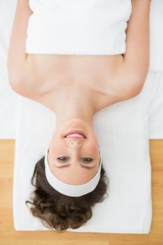 Overhead portrait of a young brunette lying on massage table in beauty salon