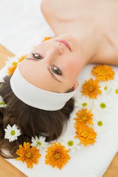 Overhead portrait of a beautiful young woman with flowers in beauty salon