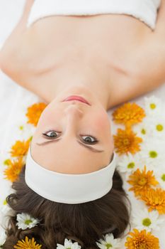 Overhead portrait of a beautiful young woman with flowers in beauty salon