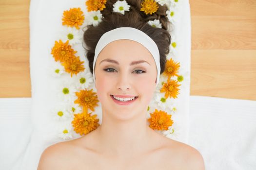 Overhead portrait of a beautiful young woman with flowers in beauty salon