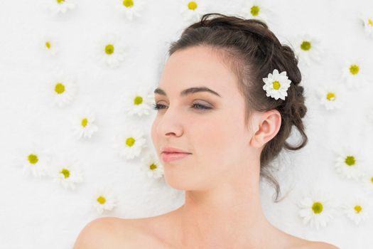 Close up of a beautiful young woman with flowers in beauty salon