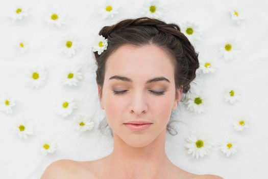 Overhead view of a beautiful young woman with flowers in beauty salon