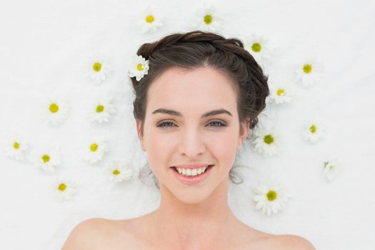 Overhead portrait of a beautiful young woman with flowers in beauty salon