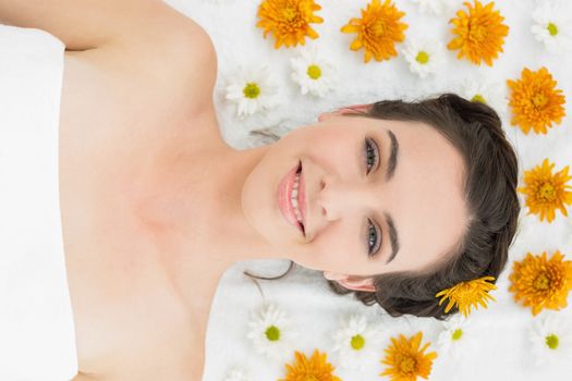 Close up portrait of a beautiful young woman with flowers in beauty salon