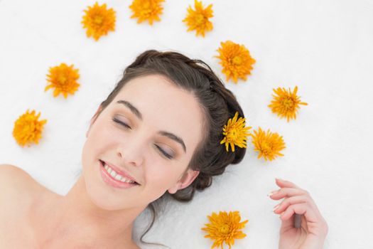 Close up of a beautiful young woman with flowers in beauty salon
