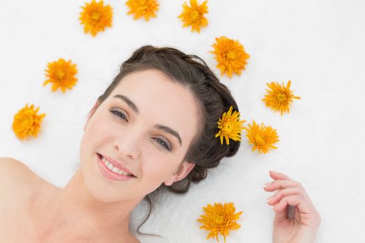Close up portrait of a beautiful young woman with flowers in beauty salon
