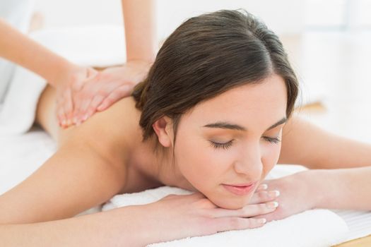 Close up of a beautiful woman enjoying back massage at beauty spa