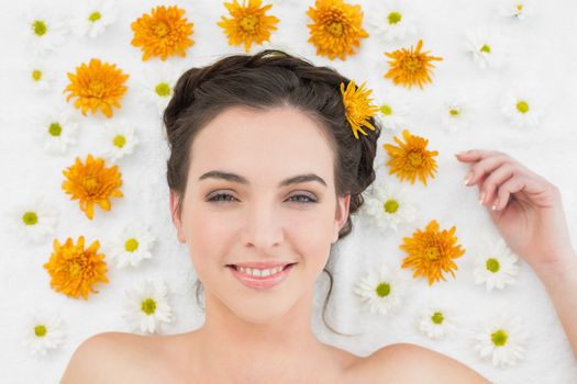 Close up portrait of a beautiful young woman with flowers in beauty salon
