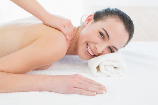 Portrait of a beautiful woman enjoying back massage at beauty spa