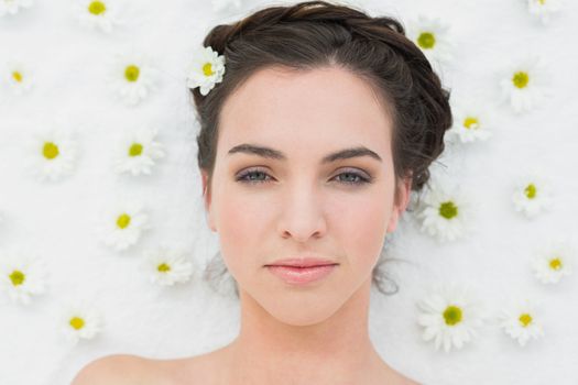 Overhead portrait of a beautiful young woman with flowers in beauty salon