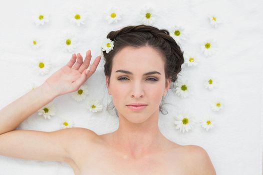 Overhead portrait of a beautiful young woman with flowers in beauty salon