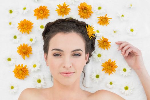 Close up portrait of a beautiful young woman with flowers in beauty salon