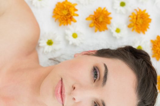 Close up portrait of a beautiful young woman with flowers in beauty salon